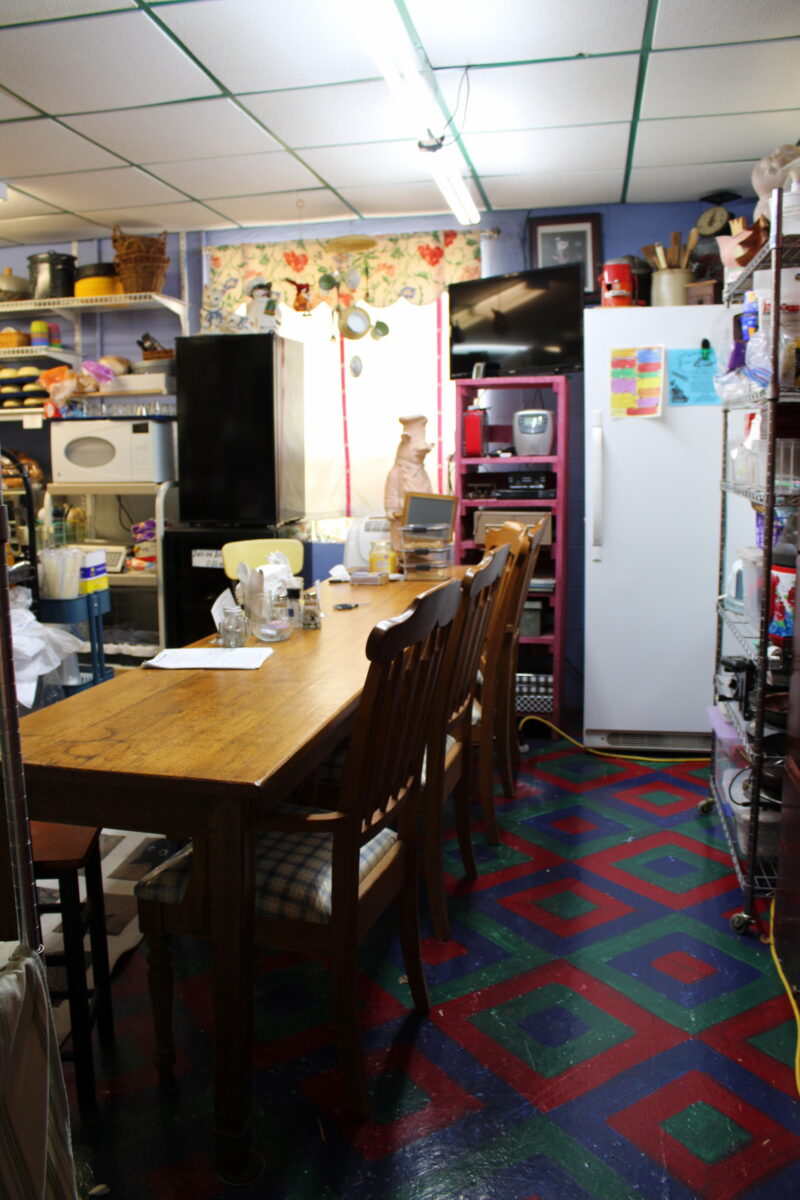 The inside of a kitchen with psychedelic flooring.