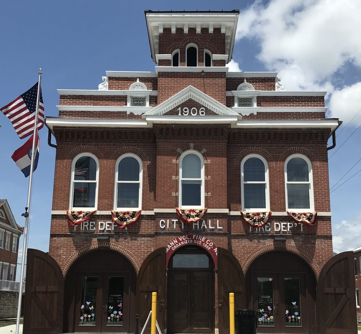 The exterior of a historic building, multi-story and built with brick.