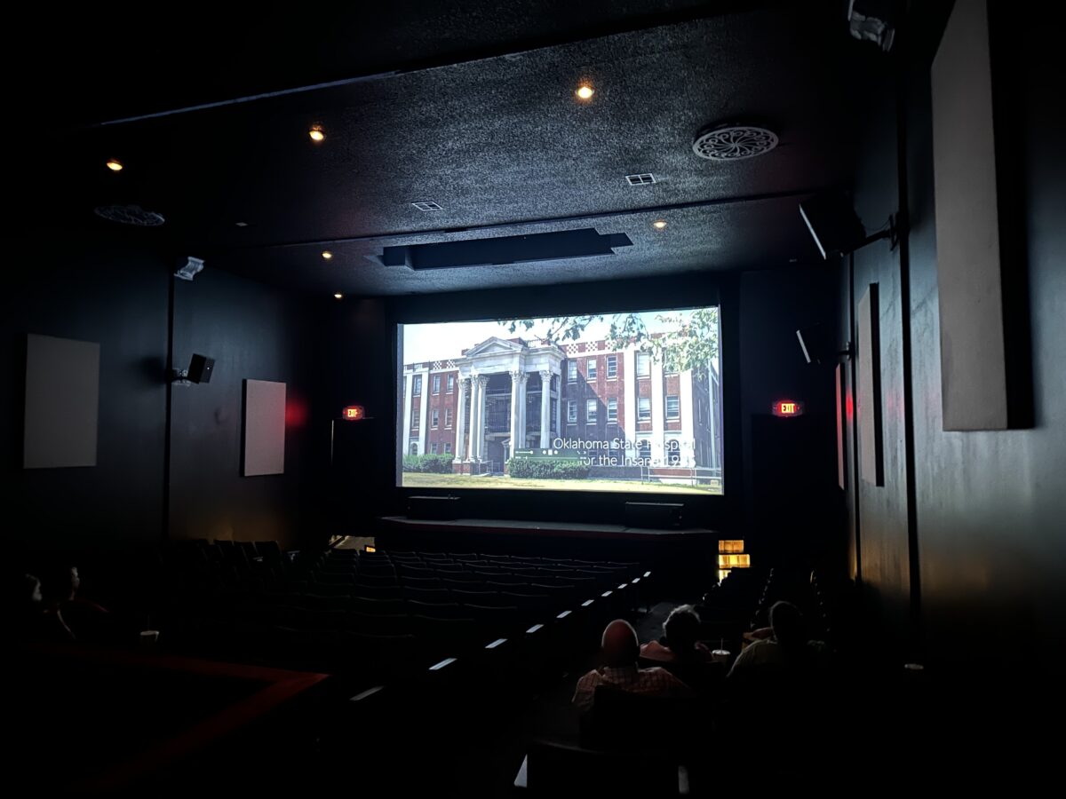 A large screen shows the opening scenes to a locally produced film, The Redemption of Mary Louisa McBroom.