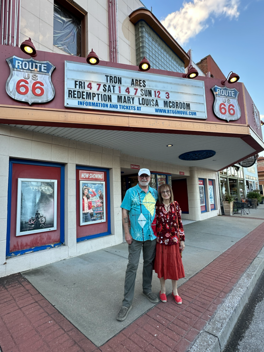 A couple pose in front go the historic Route 66 Theater in downtown Webb City, Missouri.