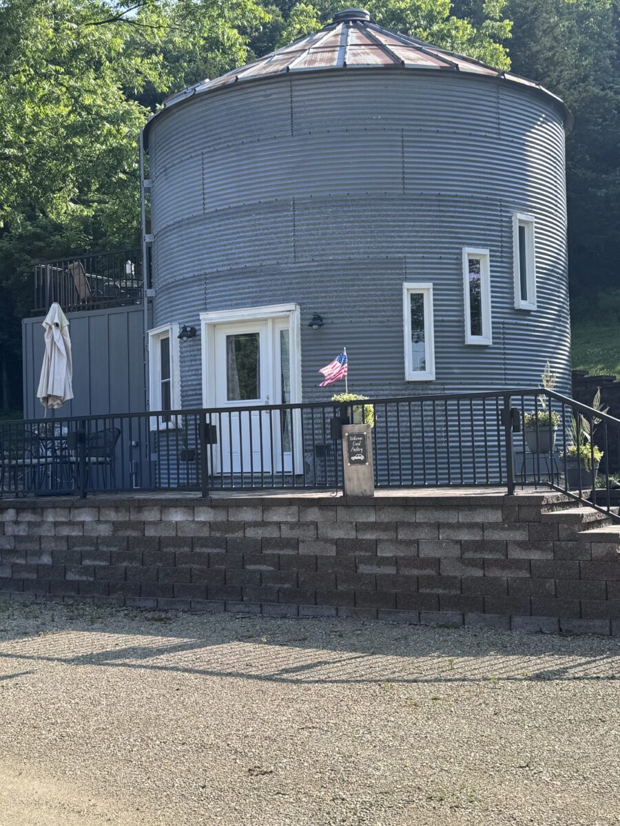 The exterior of a silo up on a paved platform.