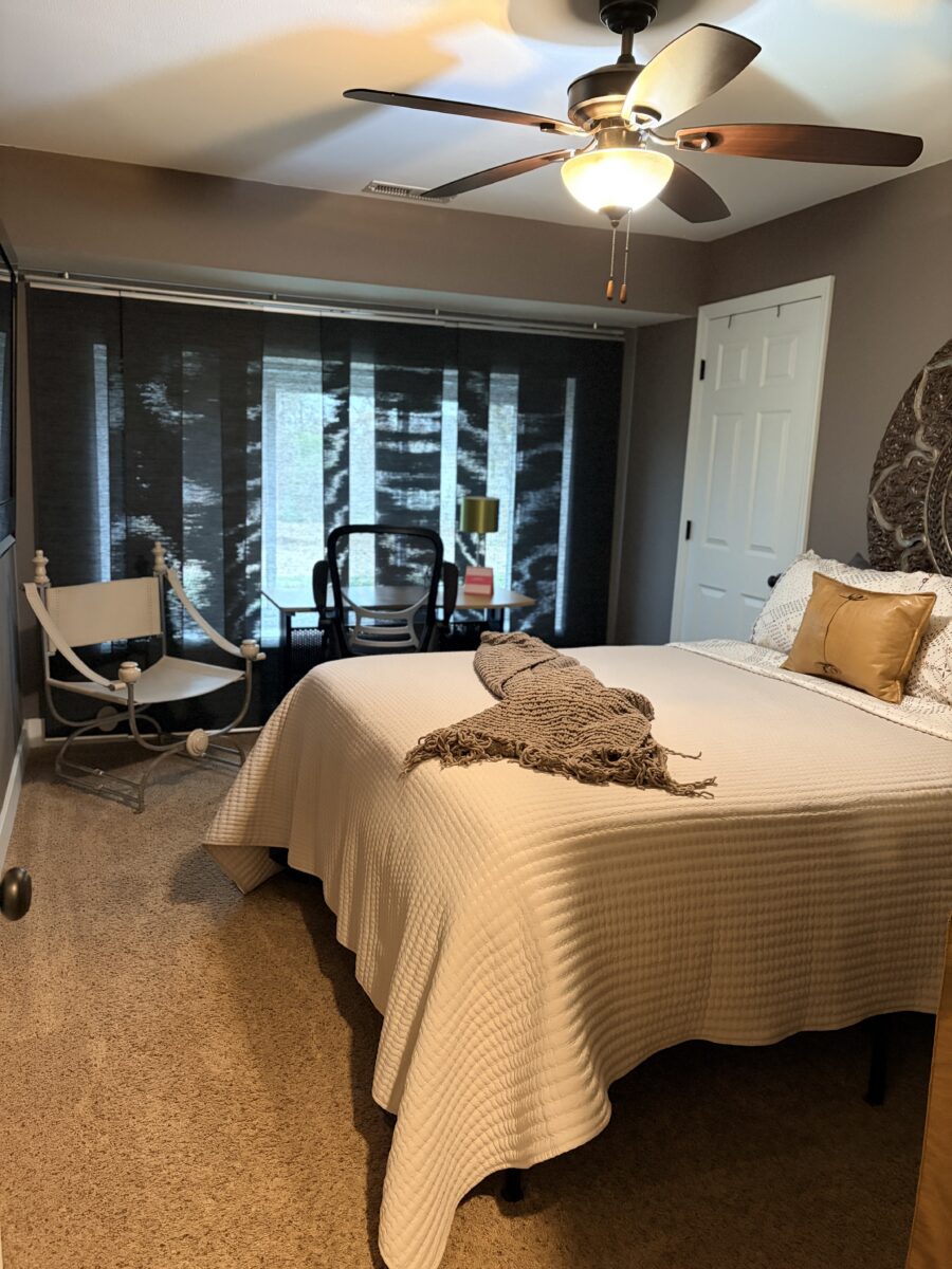 A guest room with a made bed and amenities.