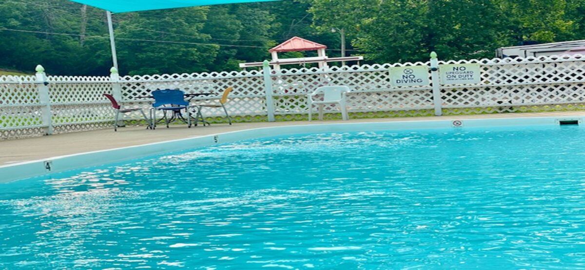 Furniture beside a pool.