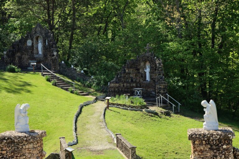 A trail surrounded by woods and rock work.