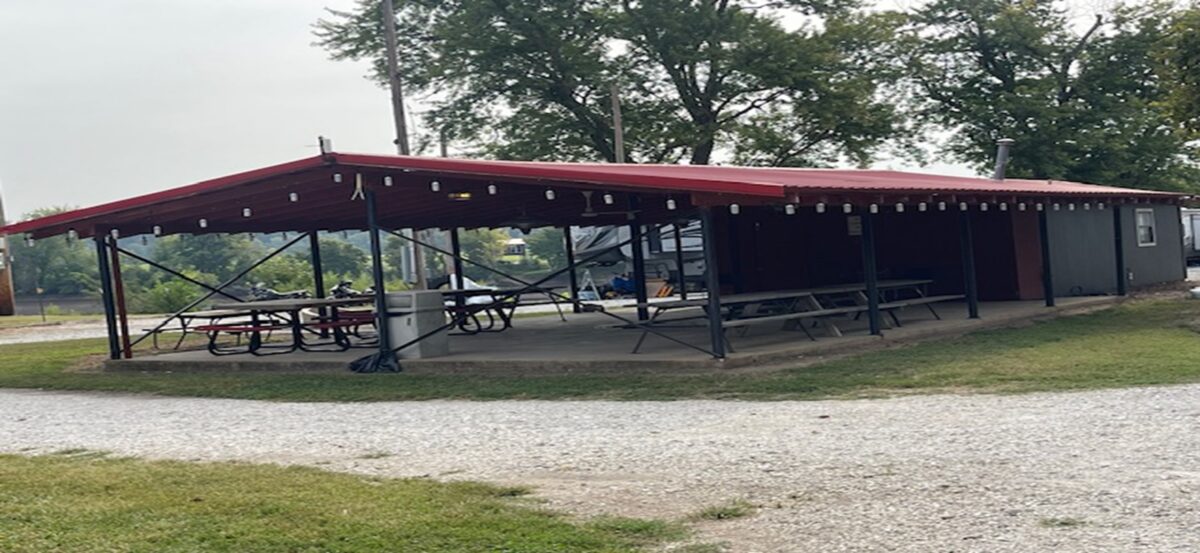 An outdoor pavilion with a red roof.