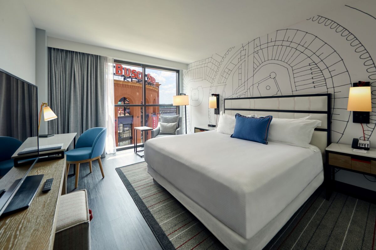 A furnished bedroom with blue and grey tones.