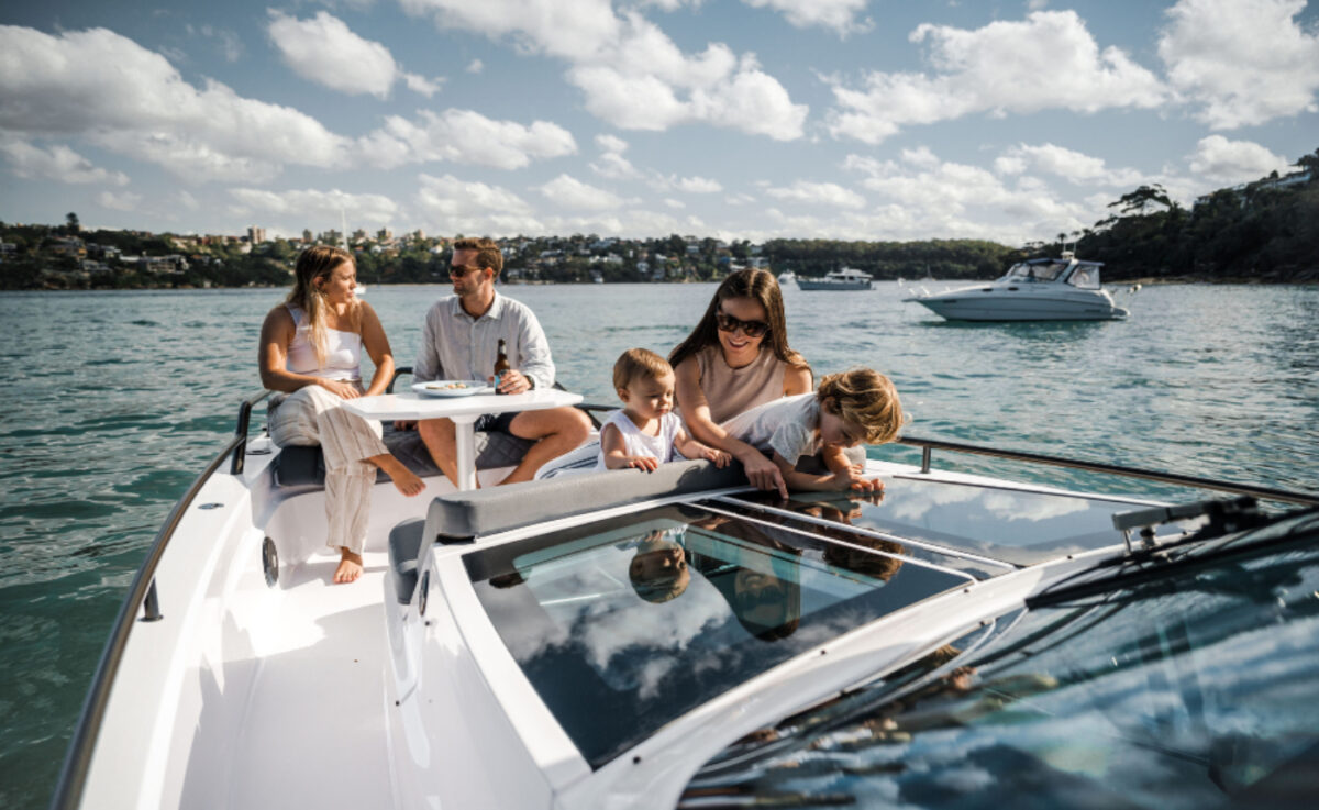 Several people on a boat while it's on the water.