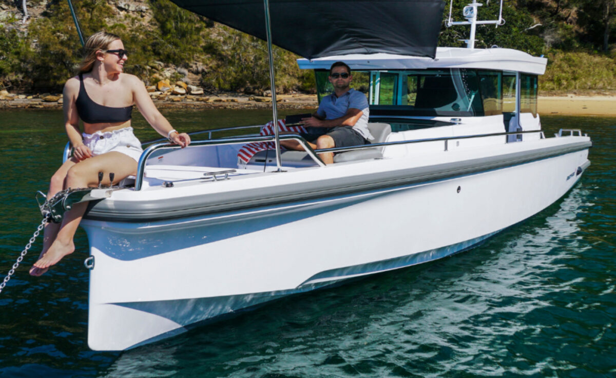 Two people on a boat sailing the water.