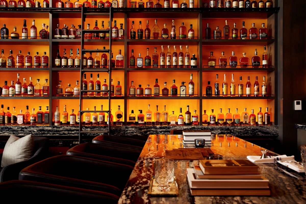 Tall shelves lit in a whiskey room.