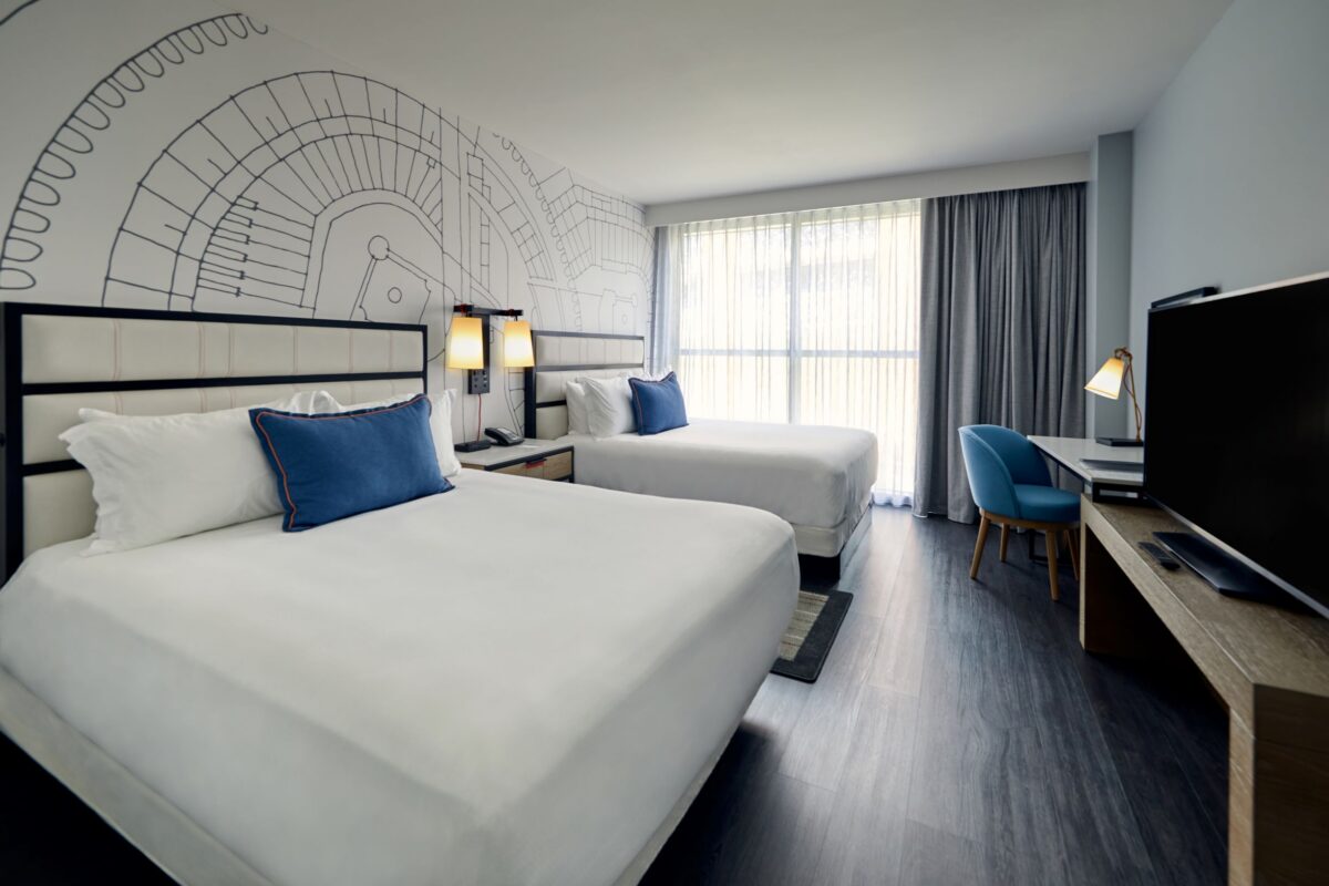 A furnished bedroom with blue and grey tones.