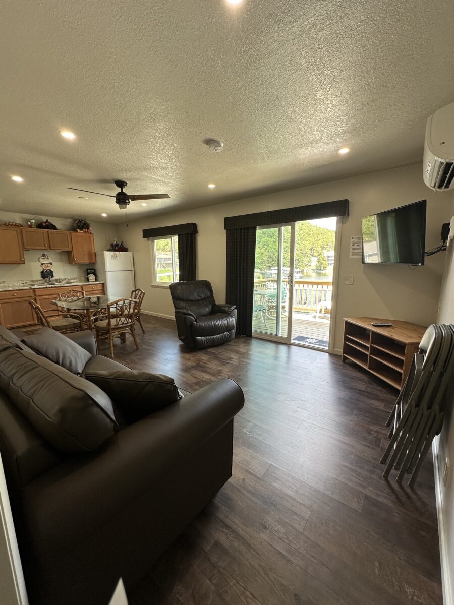 A living room with leather furniture and hardwood floors.