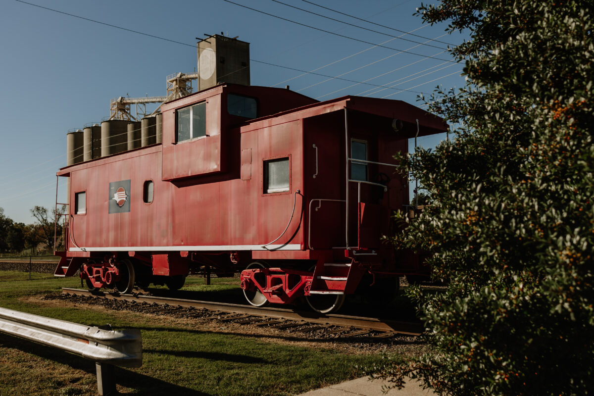 A red stationary train car on display.