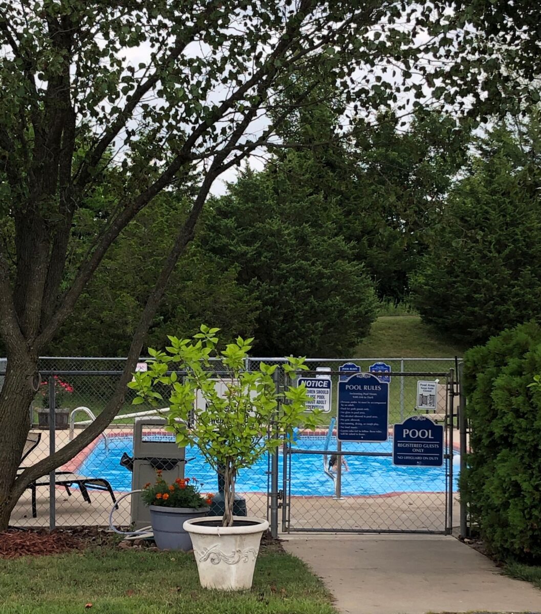 A walkway to a pool in an RV park.