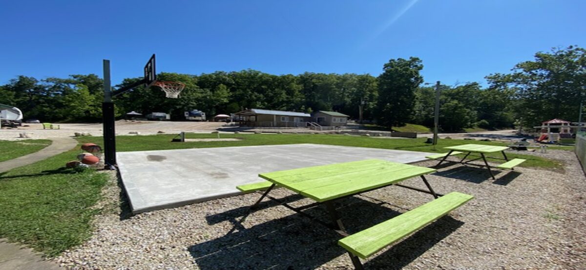Picnic tables in front of a concrete platform.