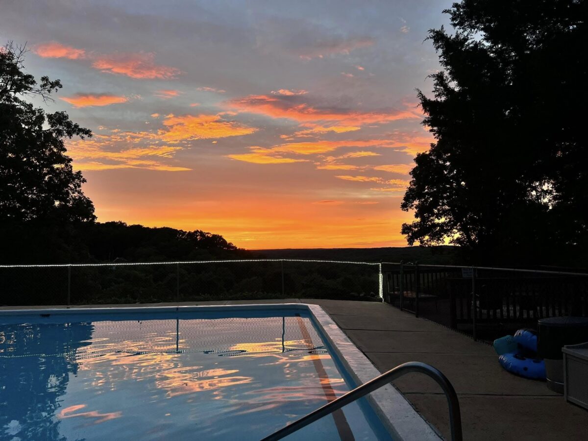 An outdoor pool at sunset.