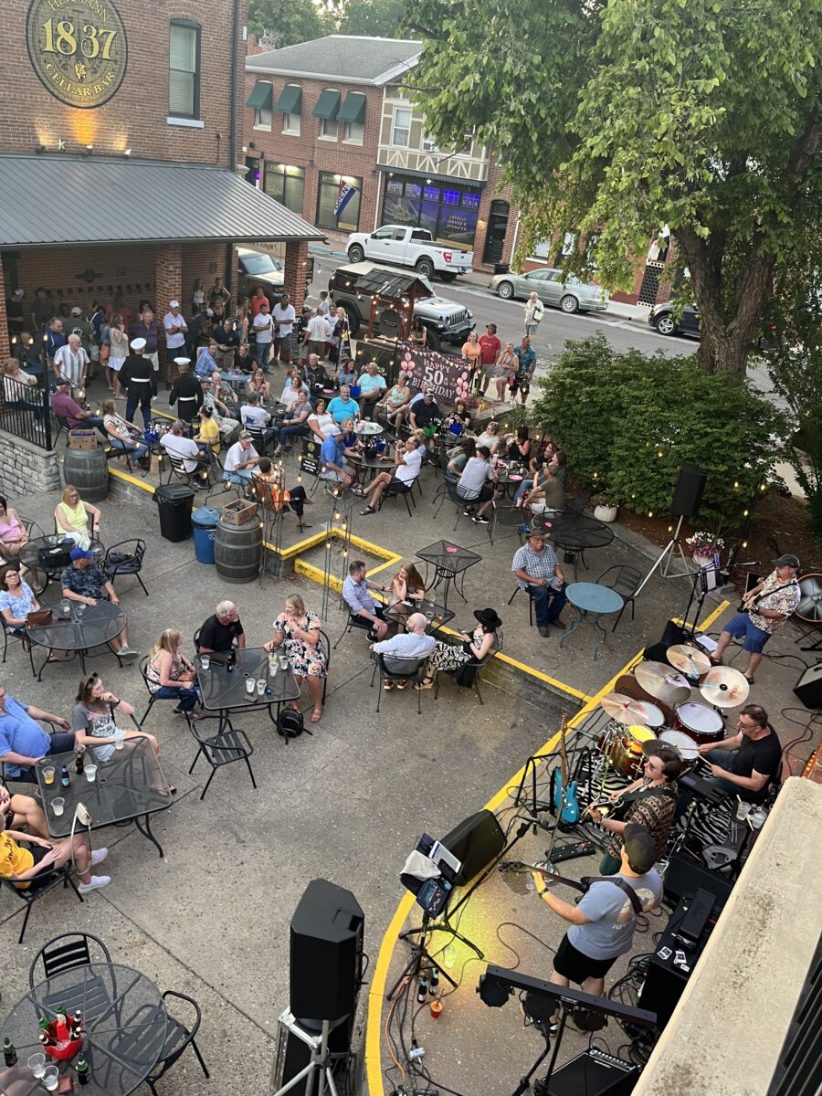 Many people seated outdoors during a show.