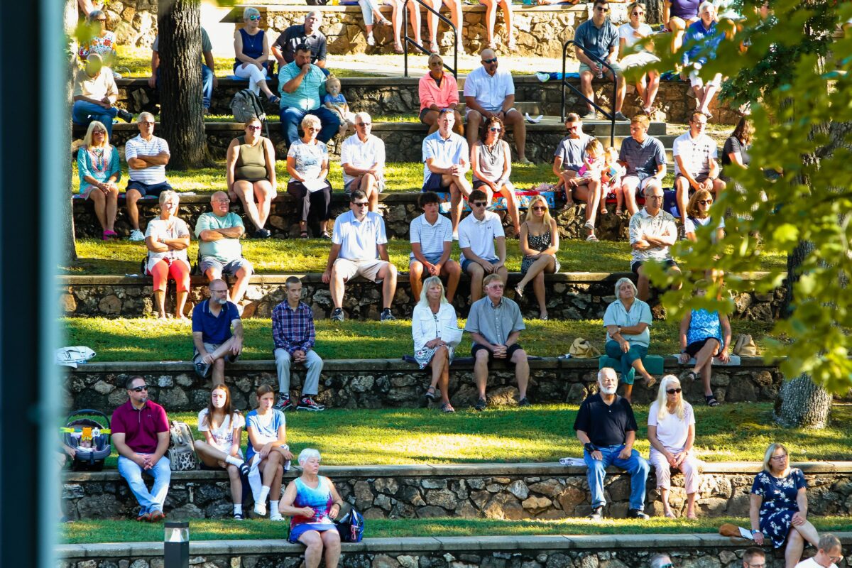 Groups of people sitting outside.