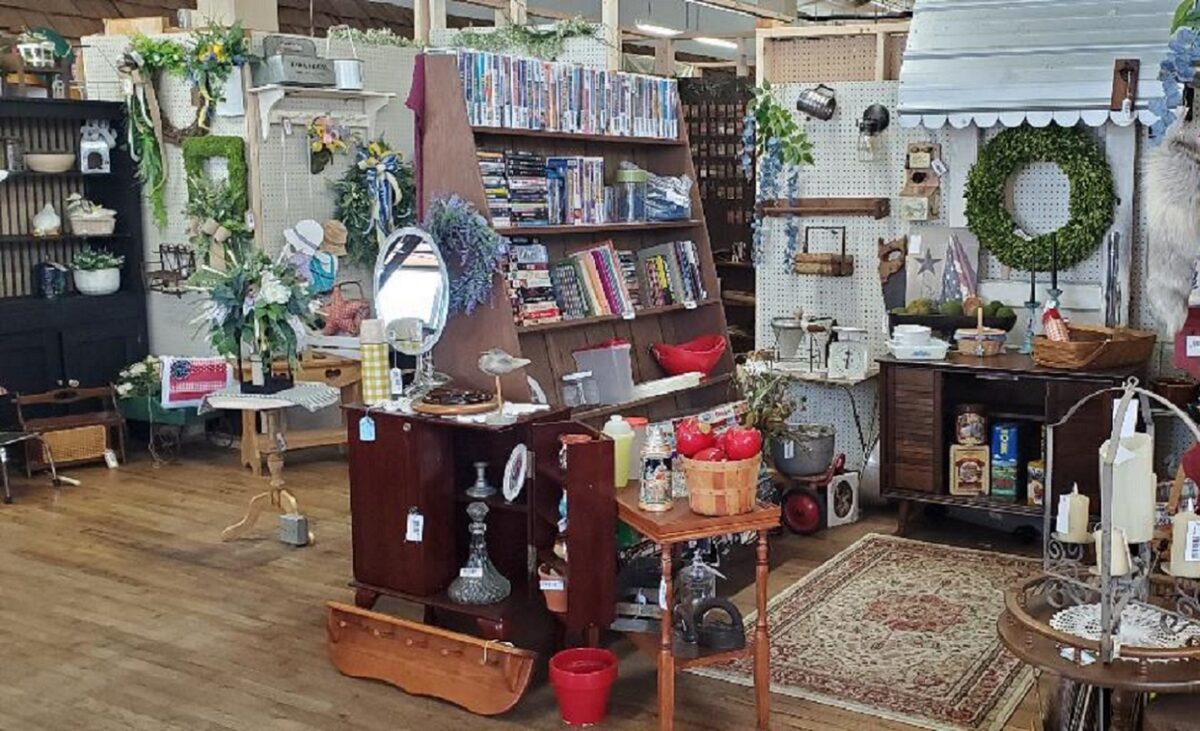 Displays of items inside a building with wood floors.