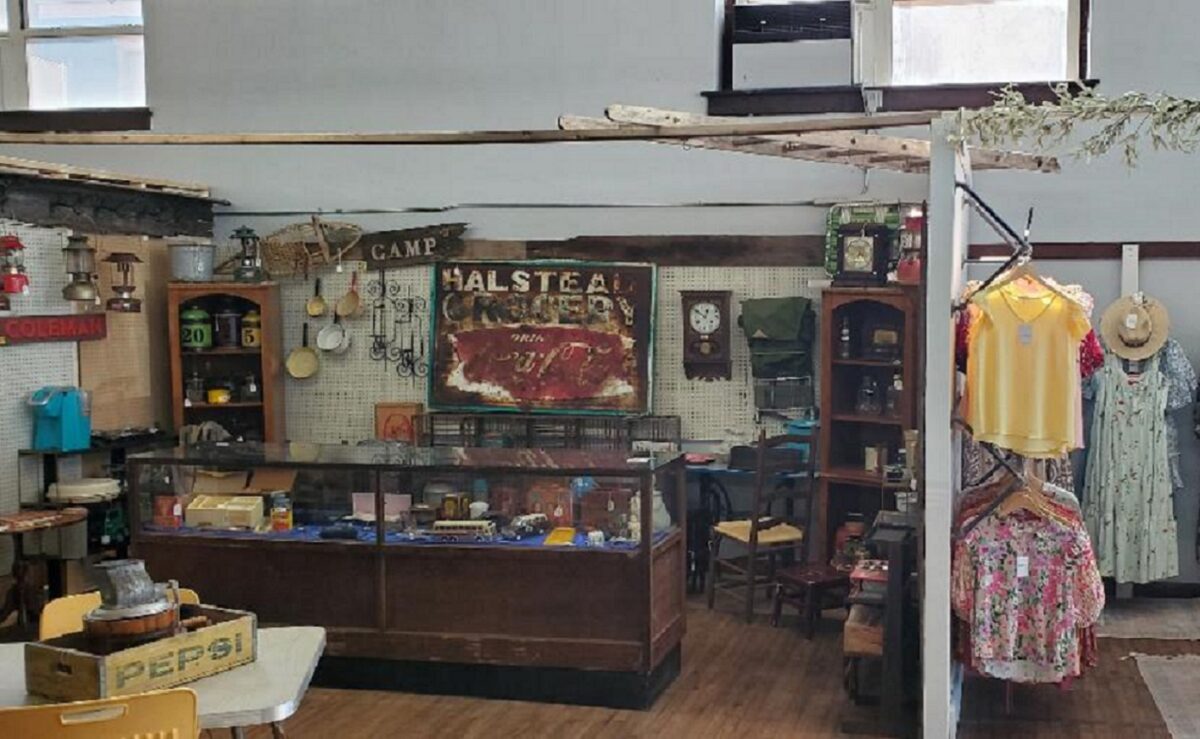 Displays of items inside a building with wood floors.