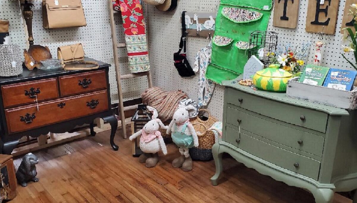 Displays of items inside a building with wood floors.