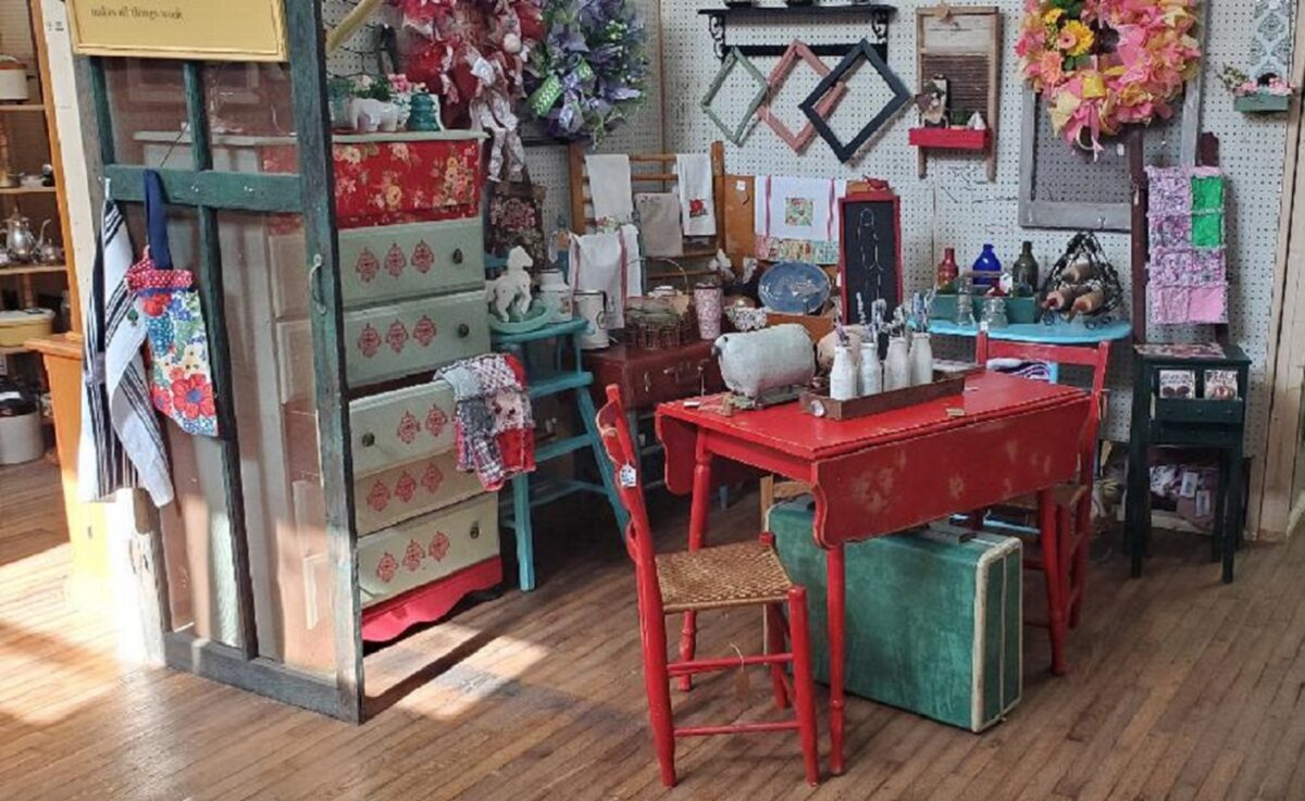Displays of items inside a building with wood floors.