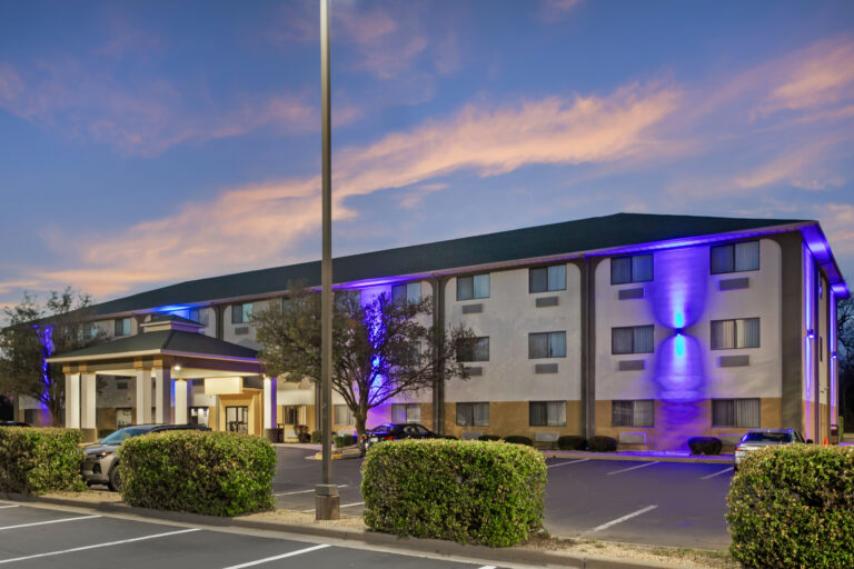The exterior of a hotel with purple lighting.