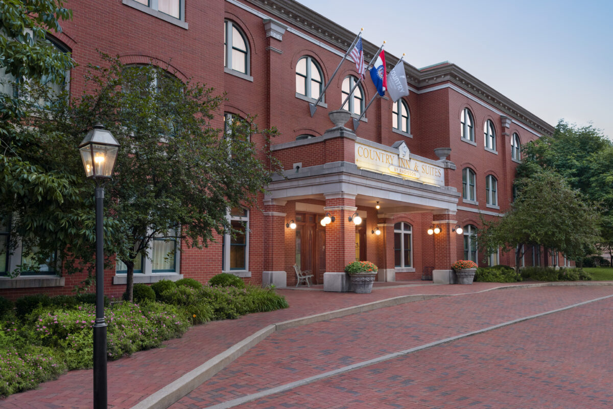 The exterior of a large hotel with brick aesthetics.