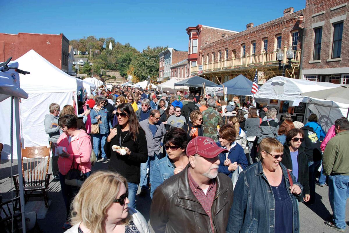 A crowd of people at an outdoor festival.