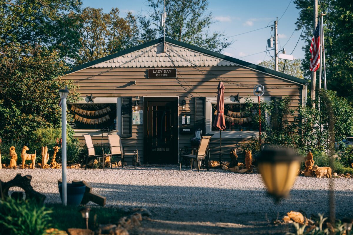 A building with things outside at a campground.