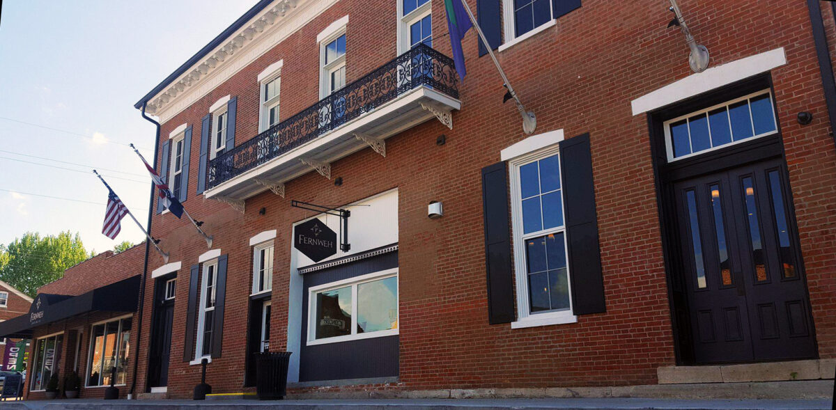 The exterior of an eclectic brick building.