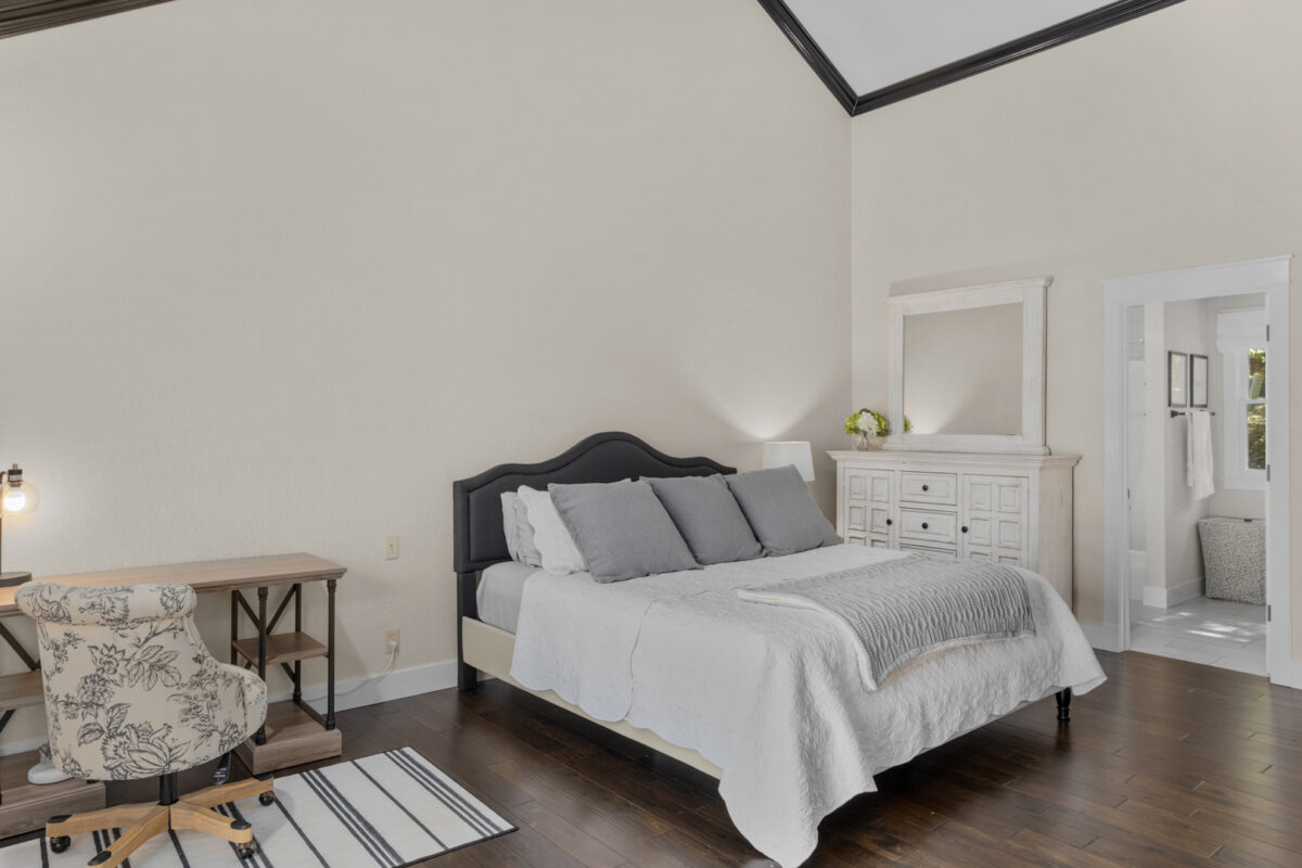 A bedroom with wood and white accents.