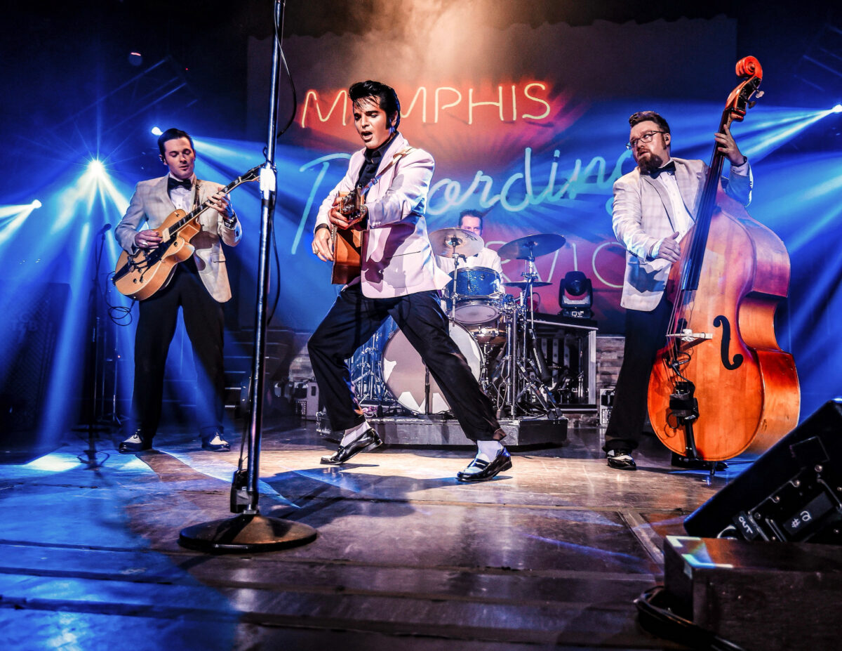 A man resembling Elivs Presley performs on stage.