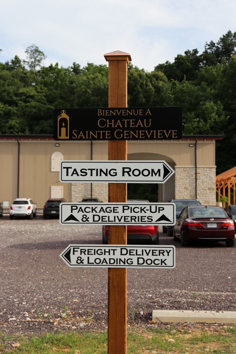 signage in front of winery production building labeled for tasting room