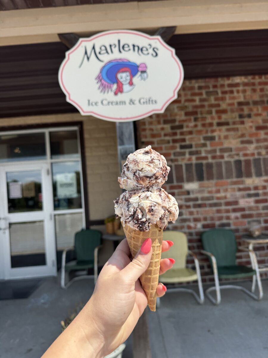 Two scoops of ice cream in a cone.
