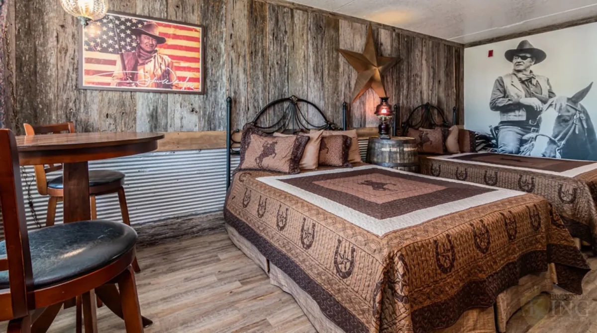 John Wayne themed room with two beds and western decor