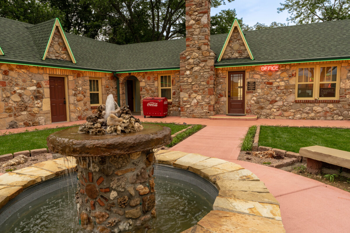 Stone motel exterior and courtyard fountain at Shamrock Court Motel in Sullivan, Missouri