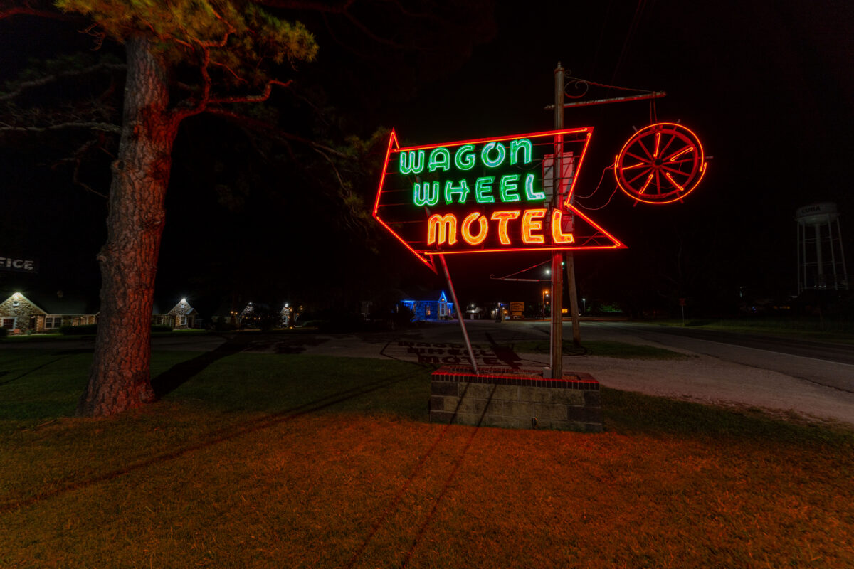 Historic Wagon Wheel Motel neon sign glowing at night on Route 66