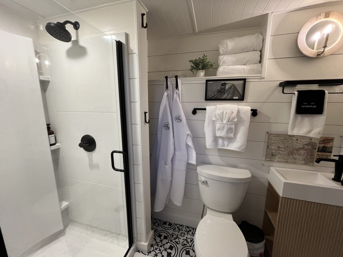 Private bathroom with 36-inch shower and H&R Caboose Roost robes inside the restored 1958 train caboose in Fredericktown, Missouri.