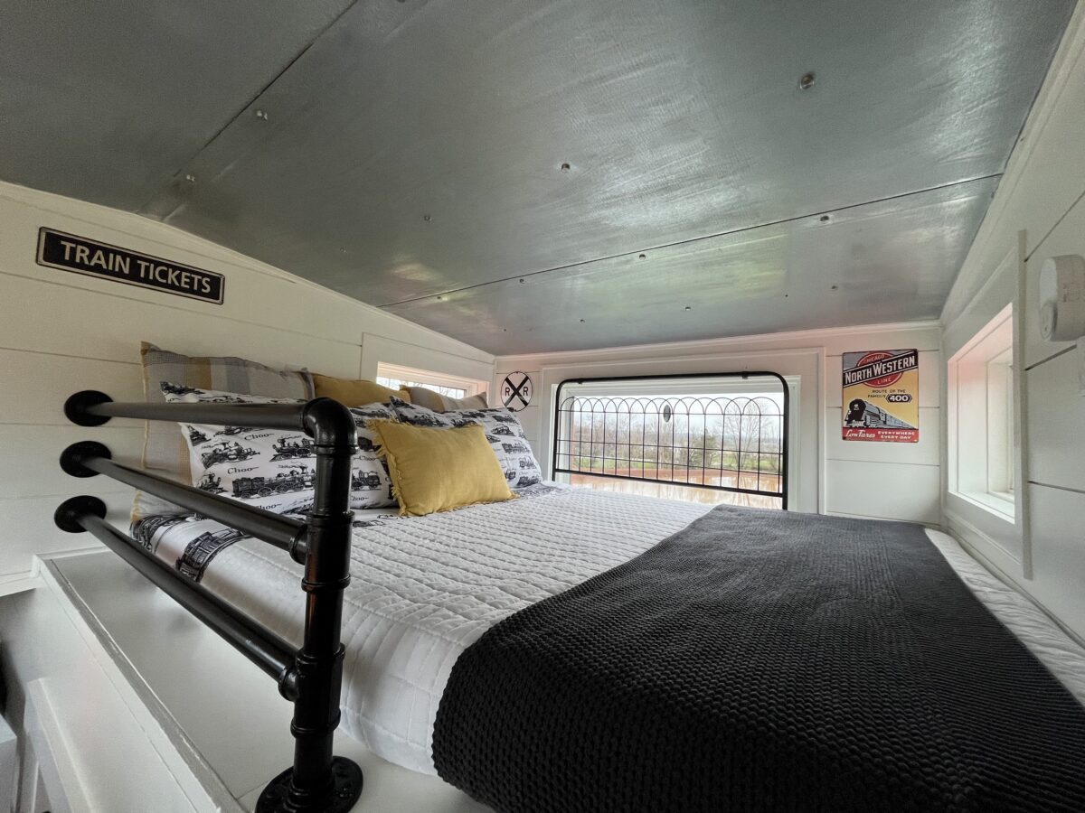 Conductor’s Loft with full-size bed inside the cupola of The H&R Caboose Roost, a restored 1958 train caboose in Fredericktown, Missouri