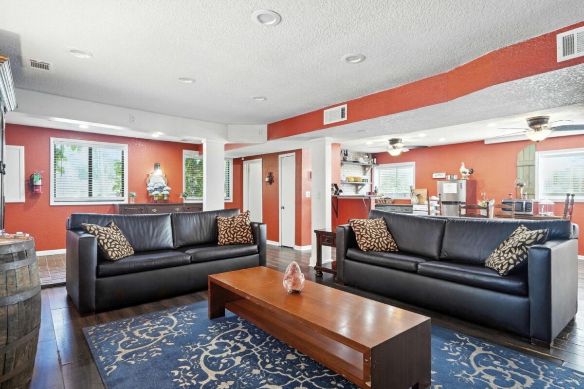 King Cabin Retreat living area with two sofas and a kitchen beyond