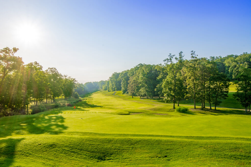 Bright green golf course on a clear sky bright blue day.